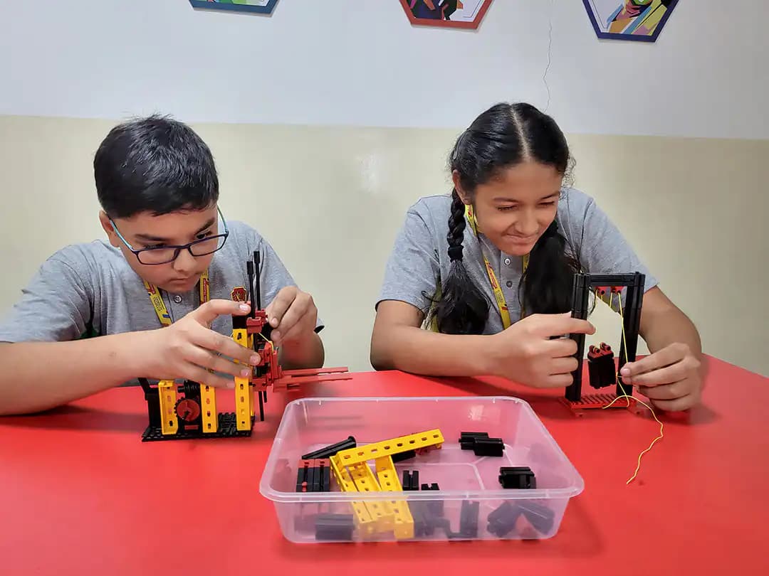 Two Suchitra students building models in the makerspace