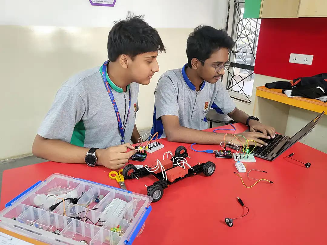 Suchitra students working on an electronics model